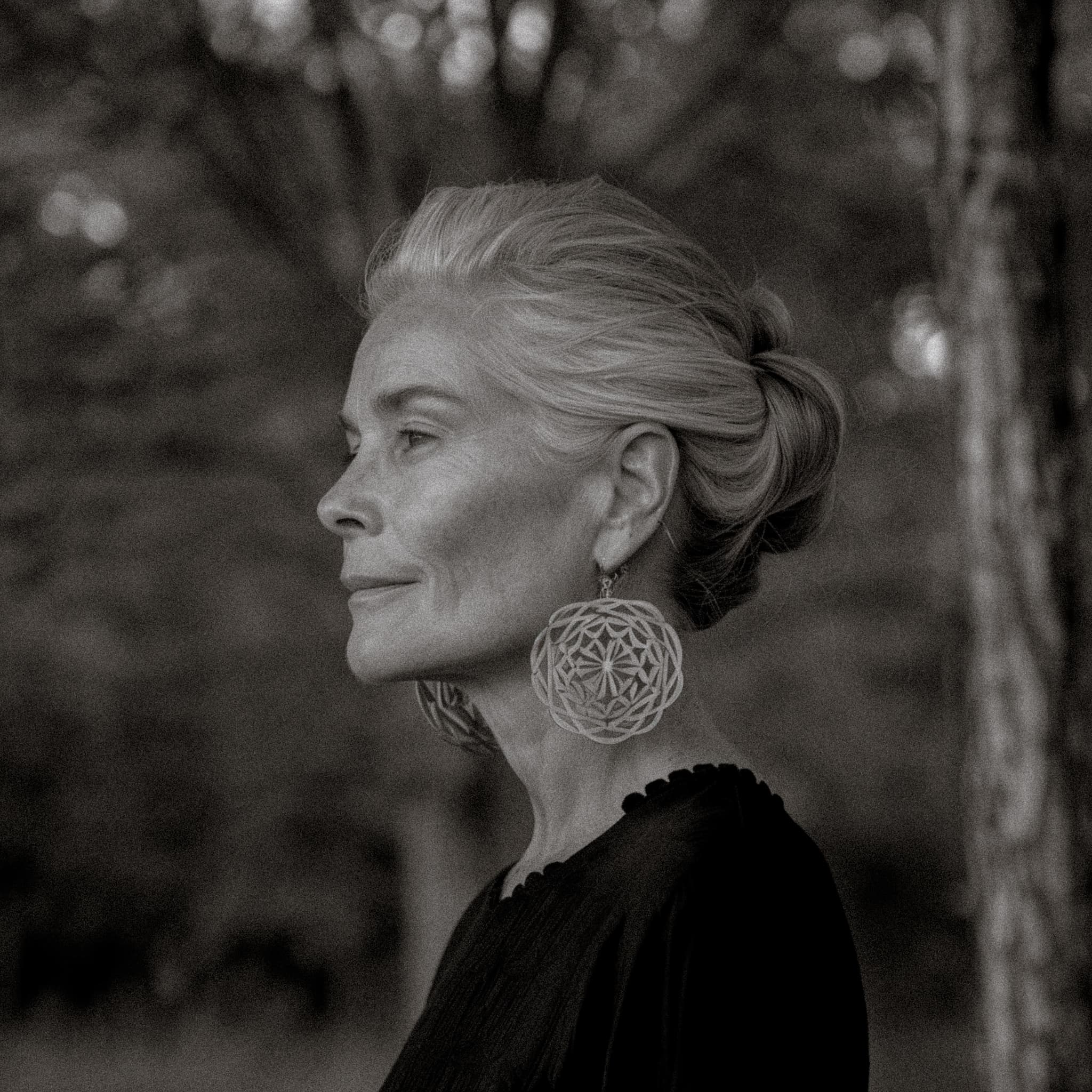 Elegant woman with silver hair and earrings