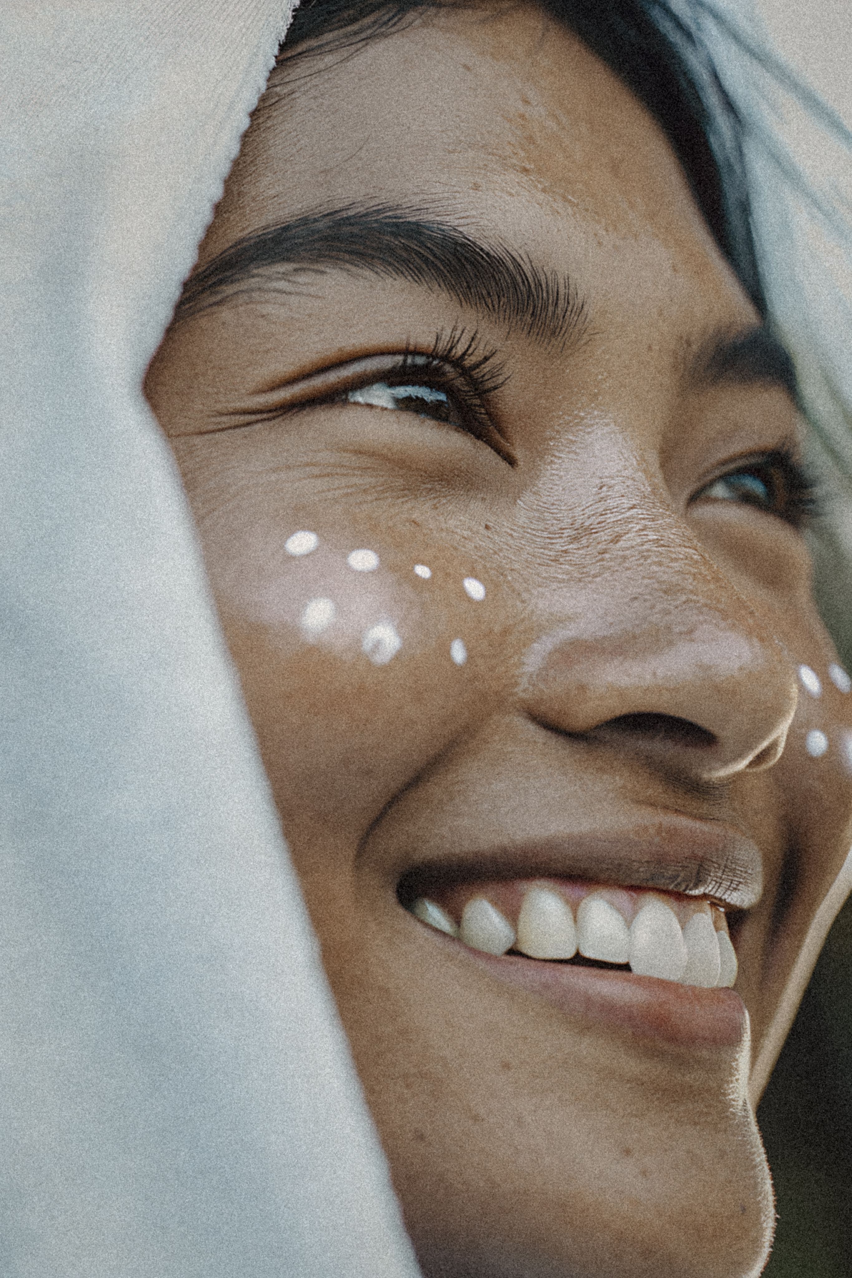 Radiant woman smiling in dappled sunlight