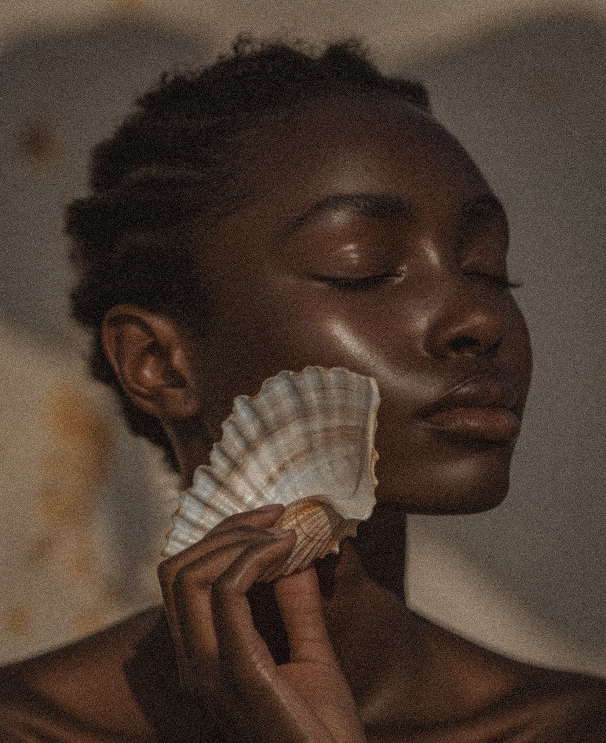 Woman with shell held to face, natural beauty