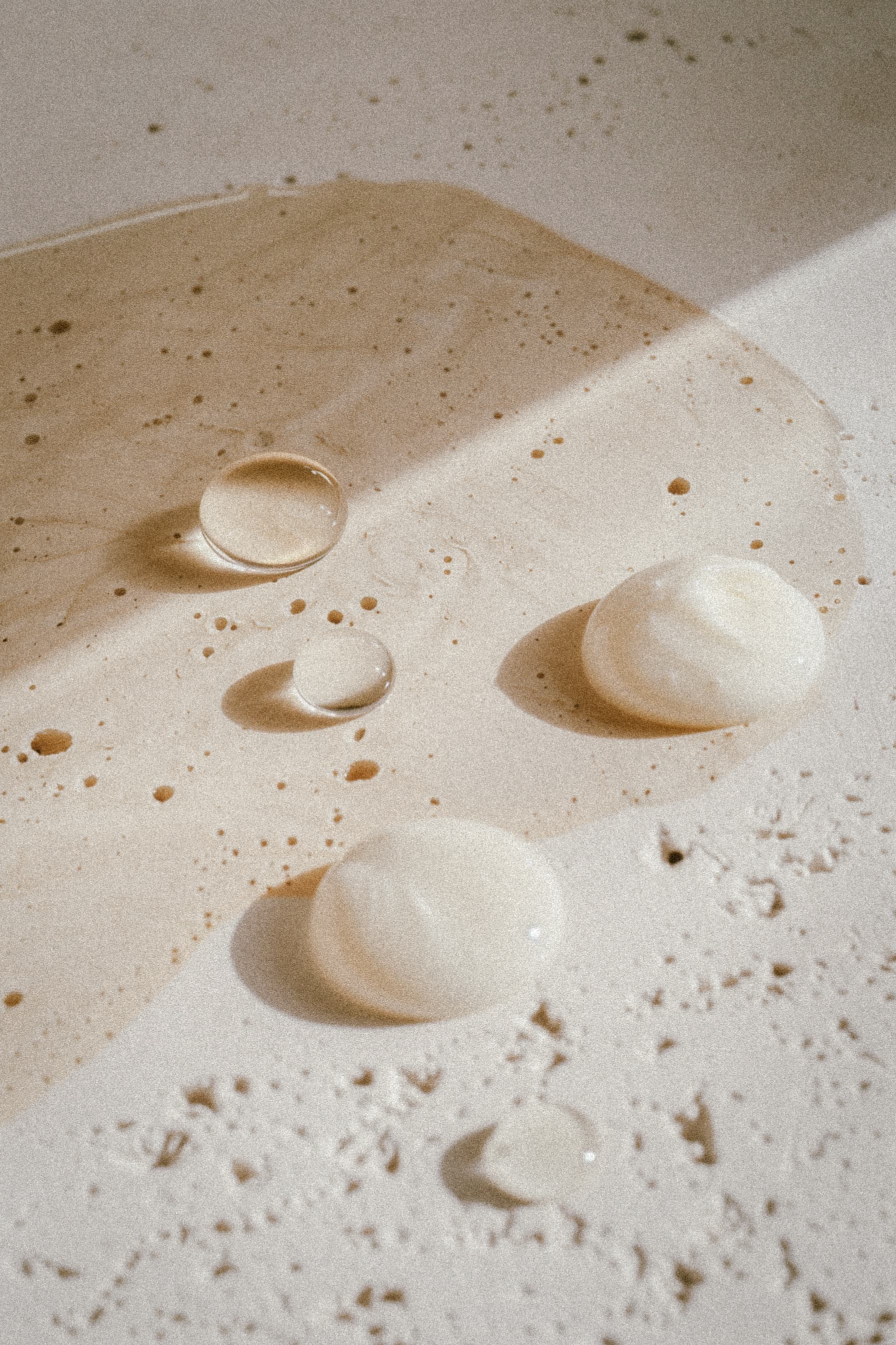 Skincare drops on warm surface